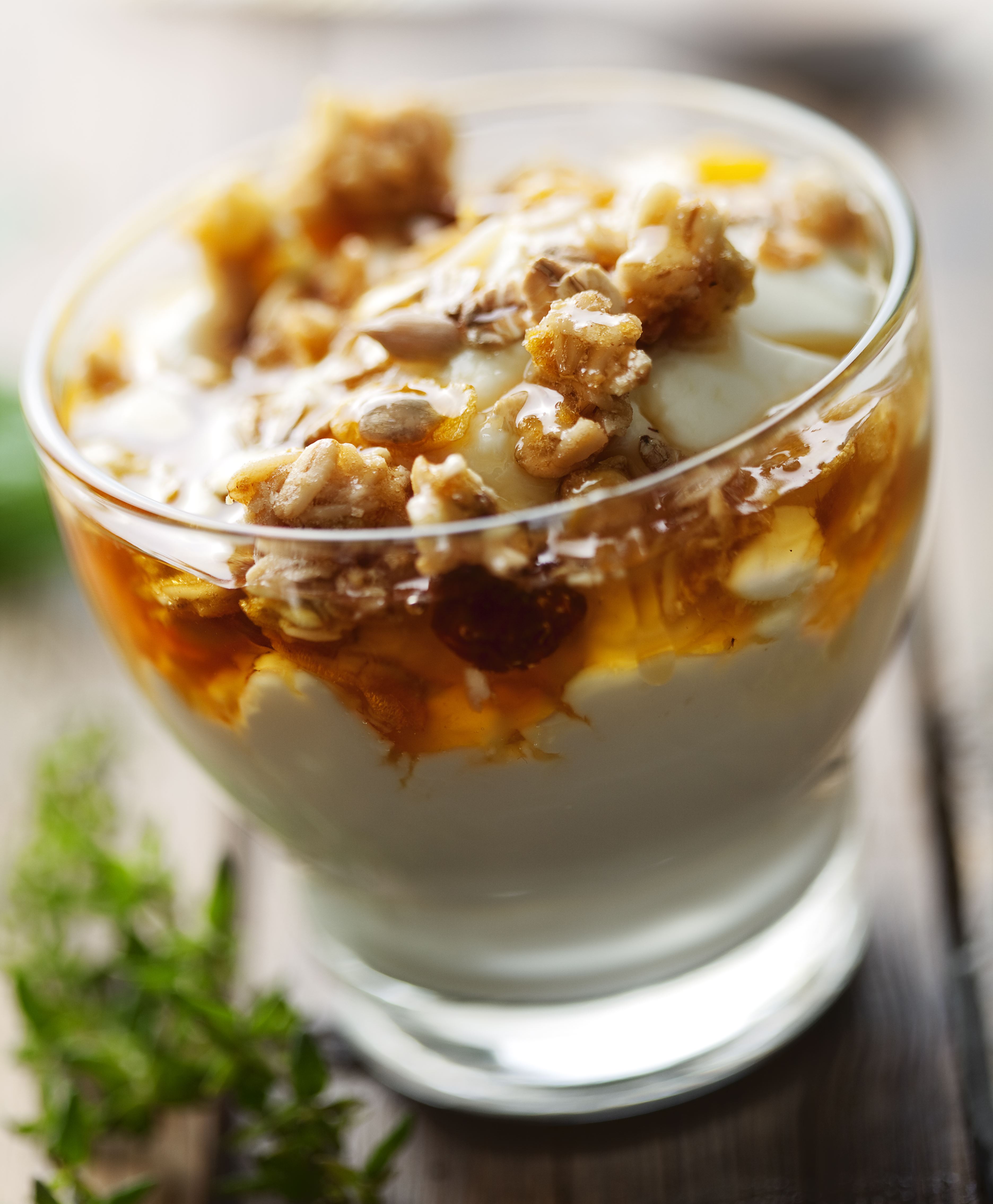 close up of greek yogurt with golden wild honey and musli