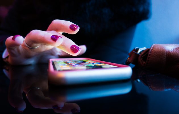 Ženska odpira aplikacijo na pametnem telefonu