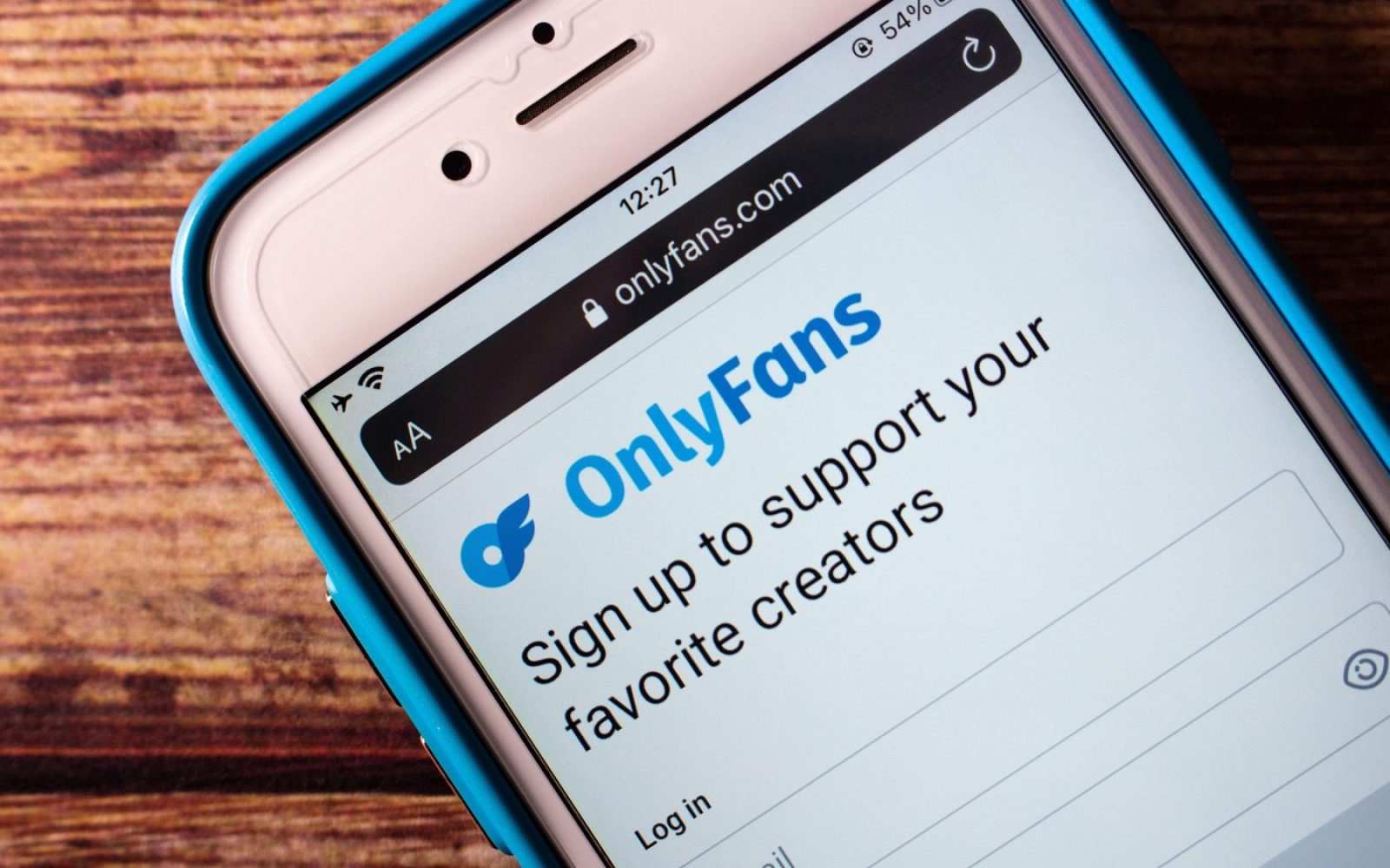 Telefon z odprto stranjo OnlyFans – simbol erotičnih aplikacij in vprašanja varanja v partnerskem odnosu