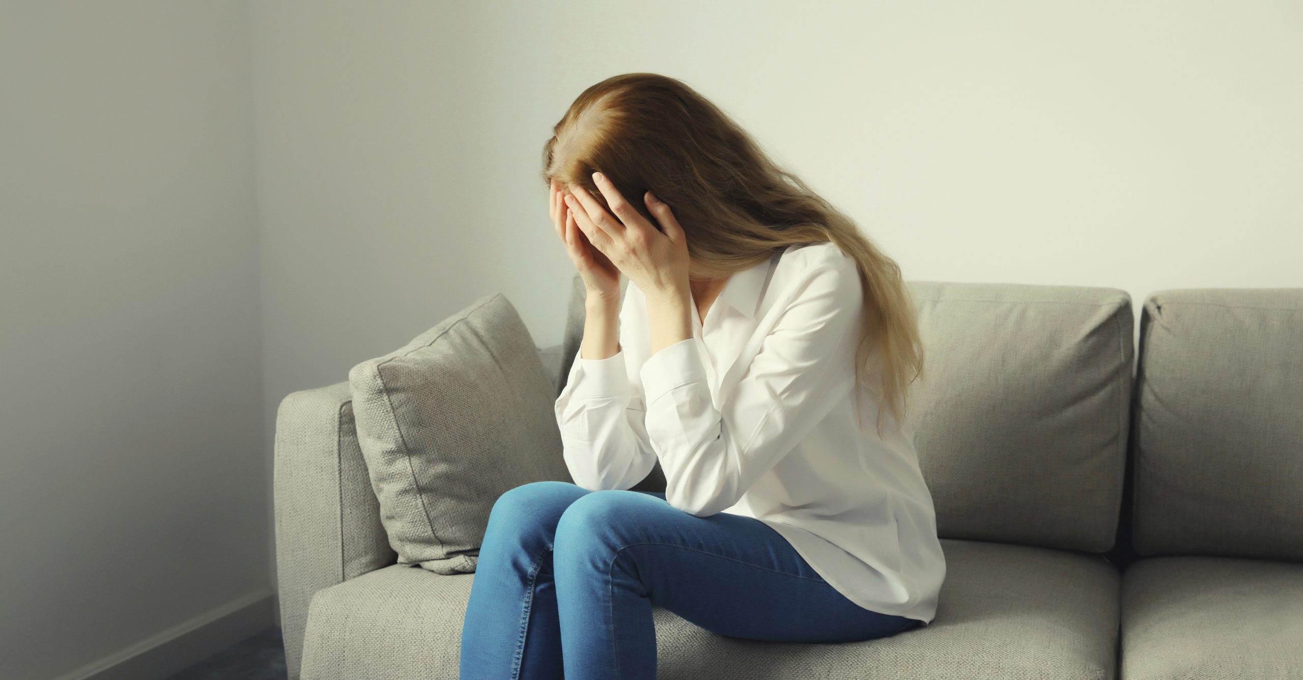 Žalostna ženska, prestrašena in zmedena, joka zaradi vpliva mentalne bolezni na njeno počutje in odnose.