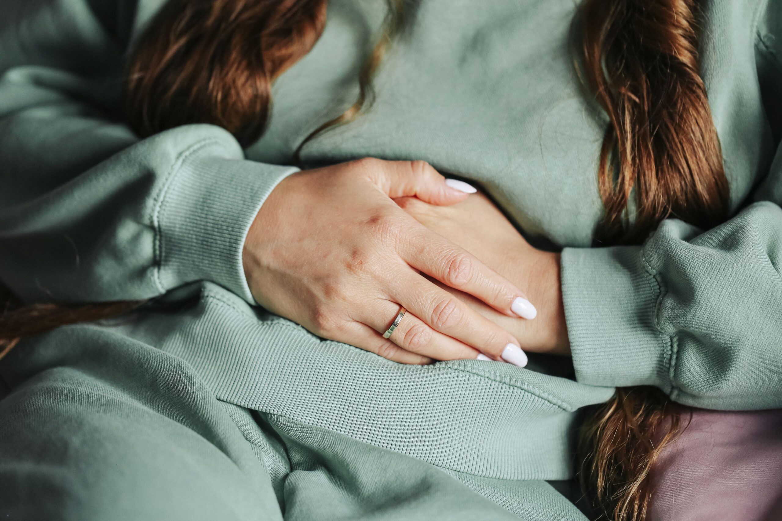 Ženska, ki se drži za trebuh zaradi bolečin v trebuhu